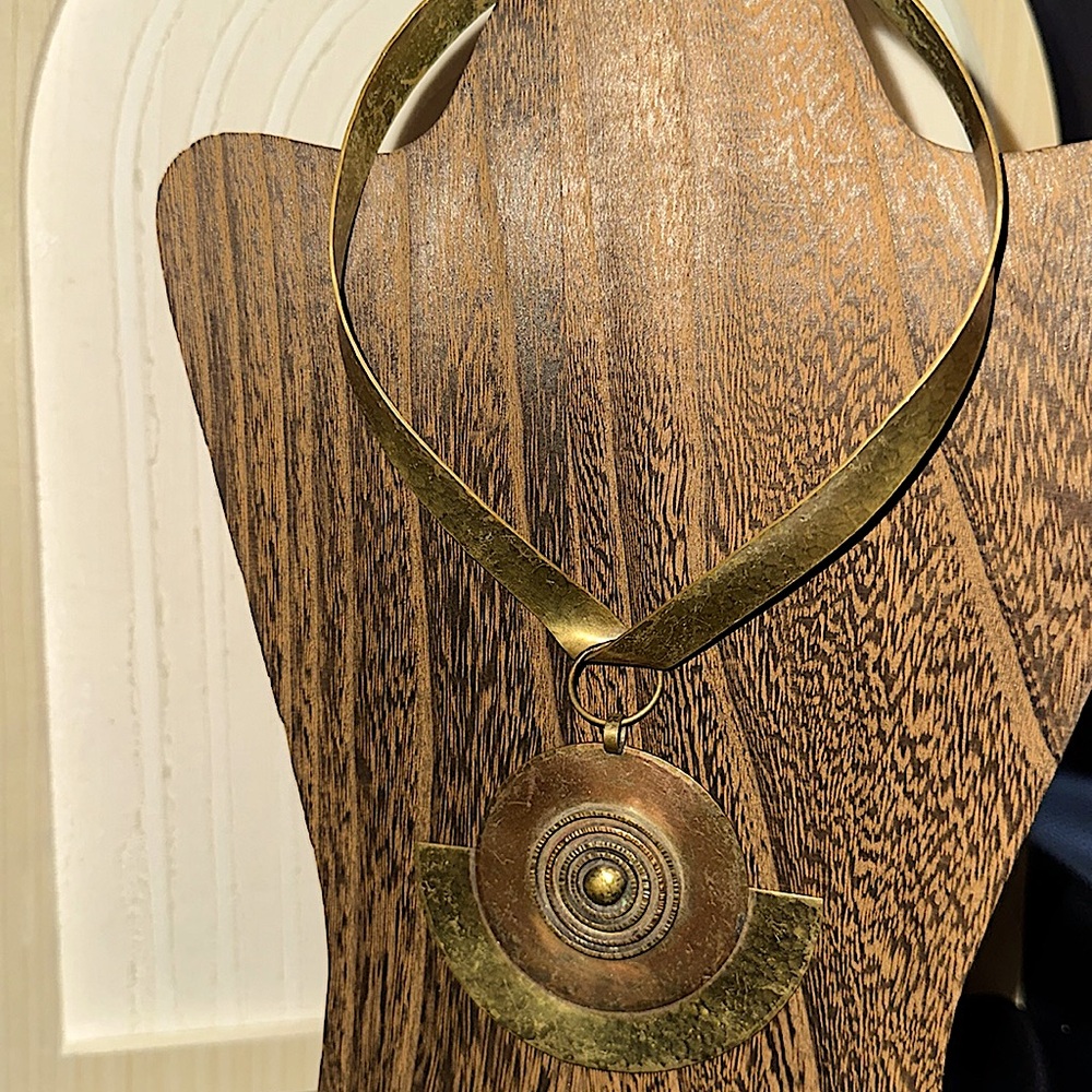 Unique vintage collar necklace with mixed metal statement pendant.